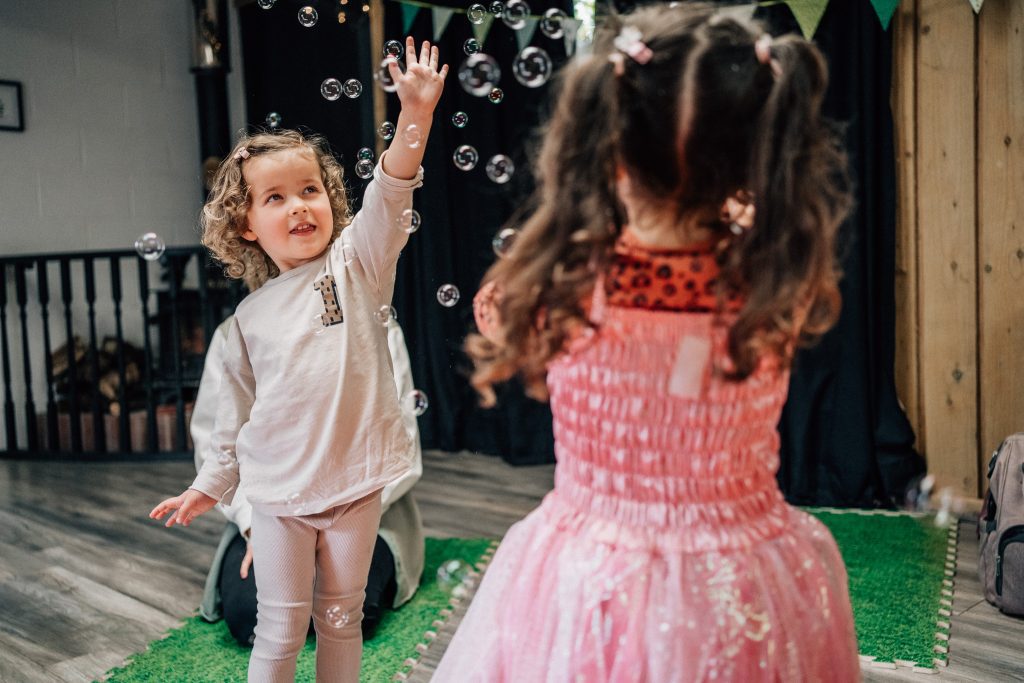 Toddler reaching for bubbles